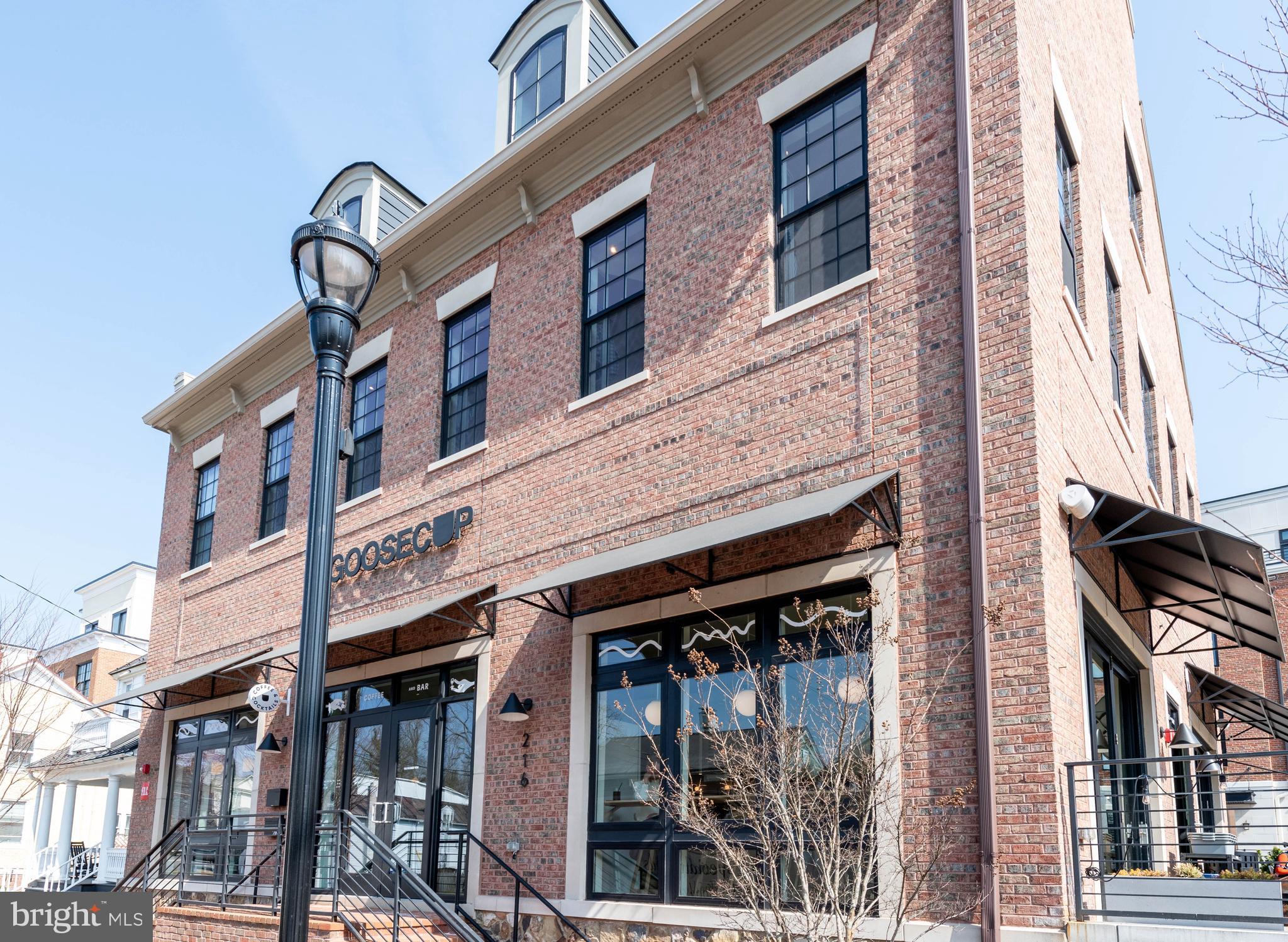 2 Stationmaster Street Southeast, Unit 302 Leesburg, VA 20175 - Photo 47 of 57 a view of a building with a door and a outdoor space