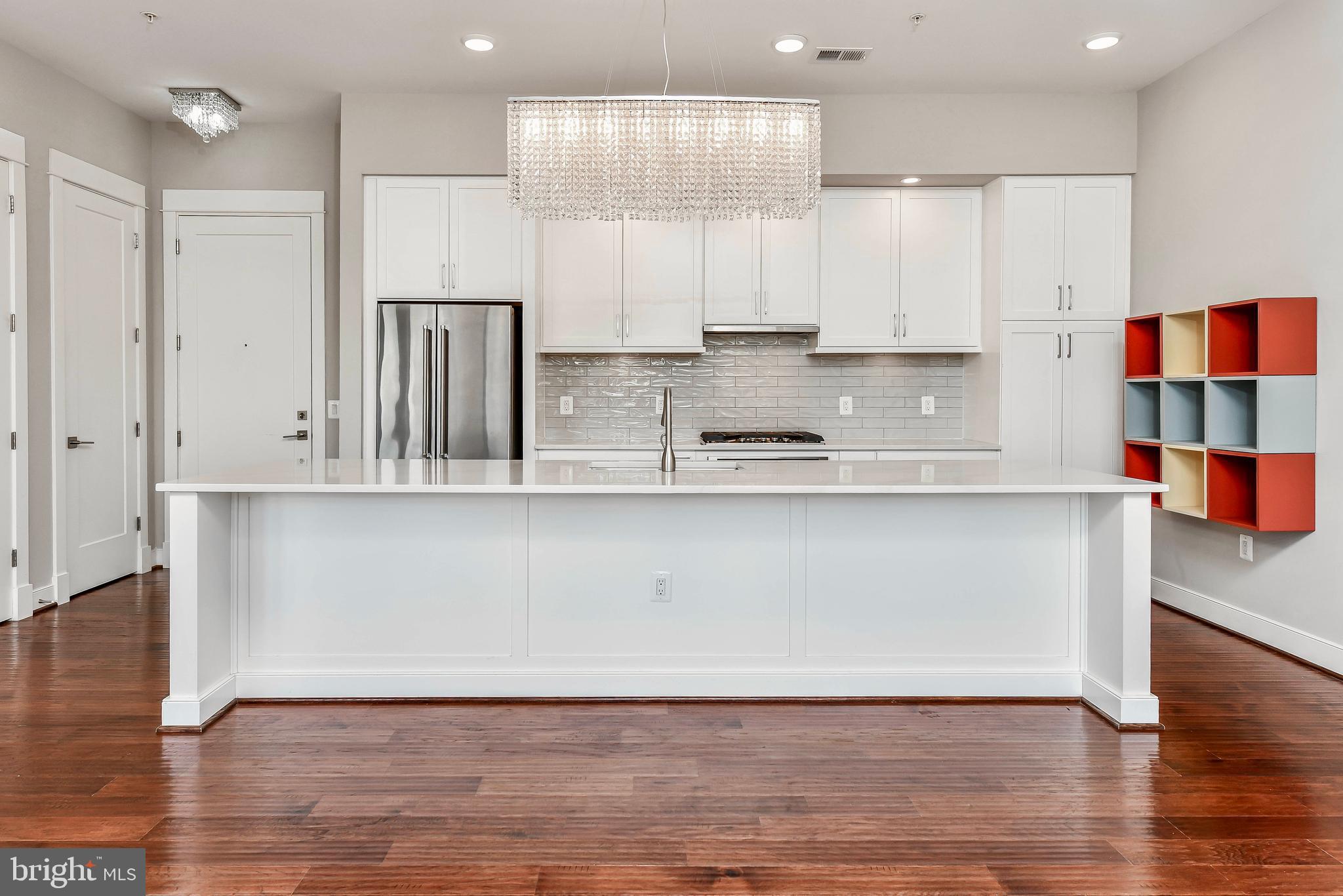 2 Stationmaster Street Southeast, Unit 302 Leesburg, VA 20175 - Photo 7 of 57 a kitchen with stainless steel appliances granite countertop a refrigerator a sink and a stove