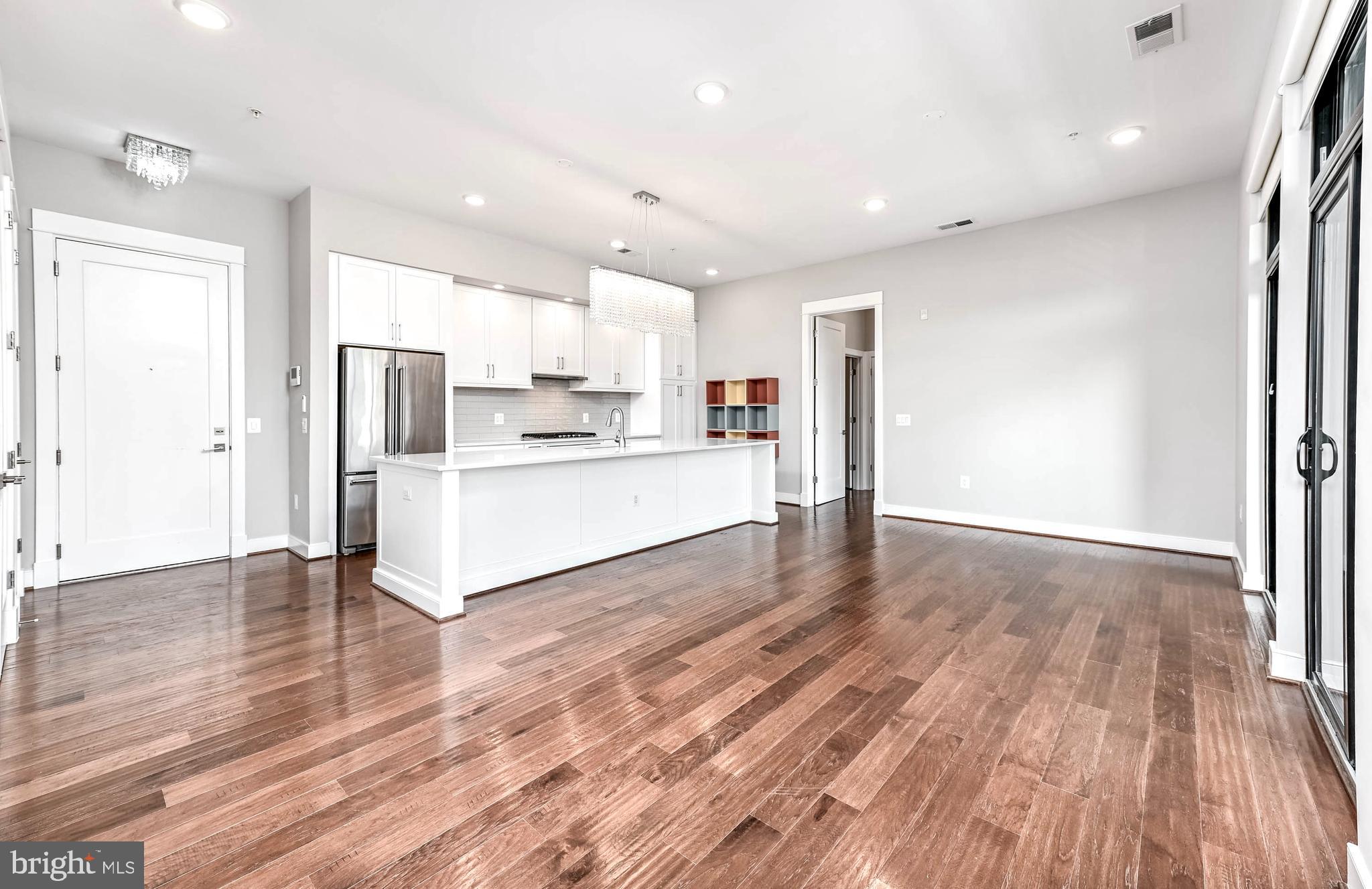 2 Stationmaster Street Southeast, Unit 302 Leesburg, VA 20175 - Photo 8 of 57 a view of kitchen view wooden floors appliances and cabinets