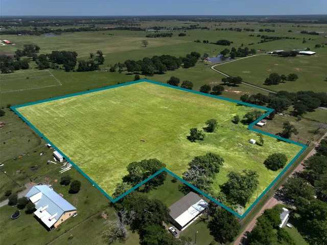 an aerial view of a golf course with a lake view