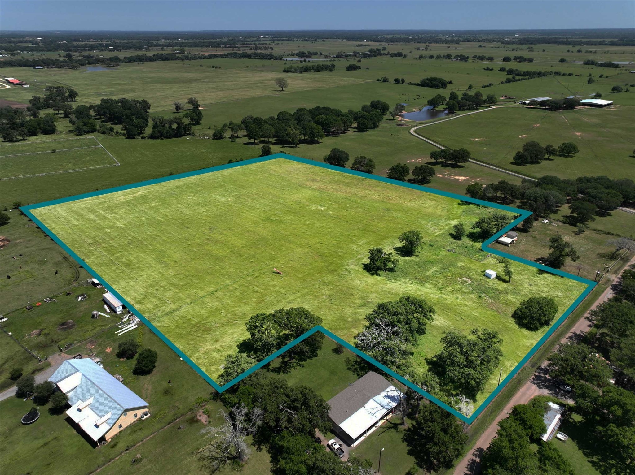 an aerial view of a golf course with a lake view