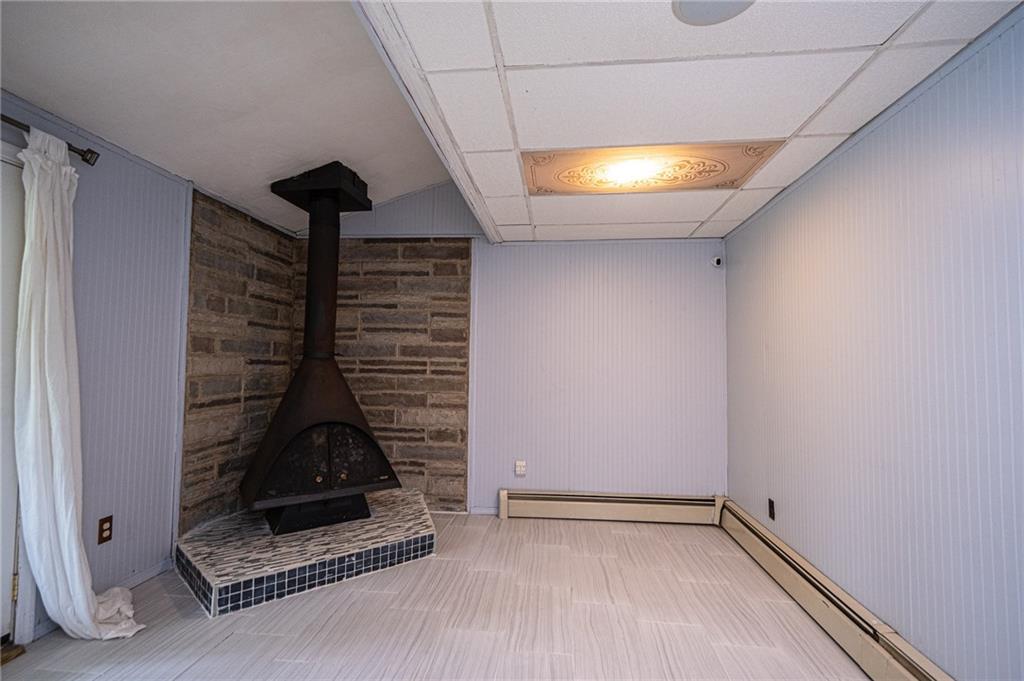 808 Jefferson Road Pittsburgh, PA 15235 - Photo 16 of 25 Family room with wood burner just behind the garage.