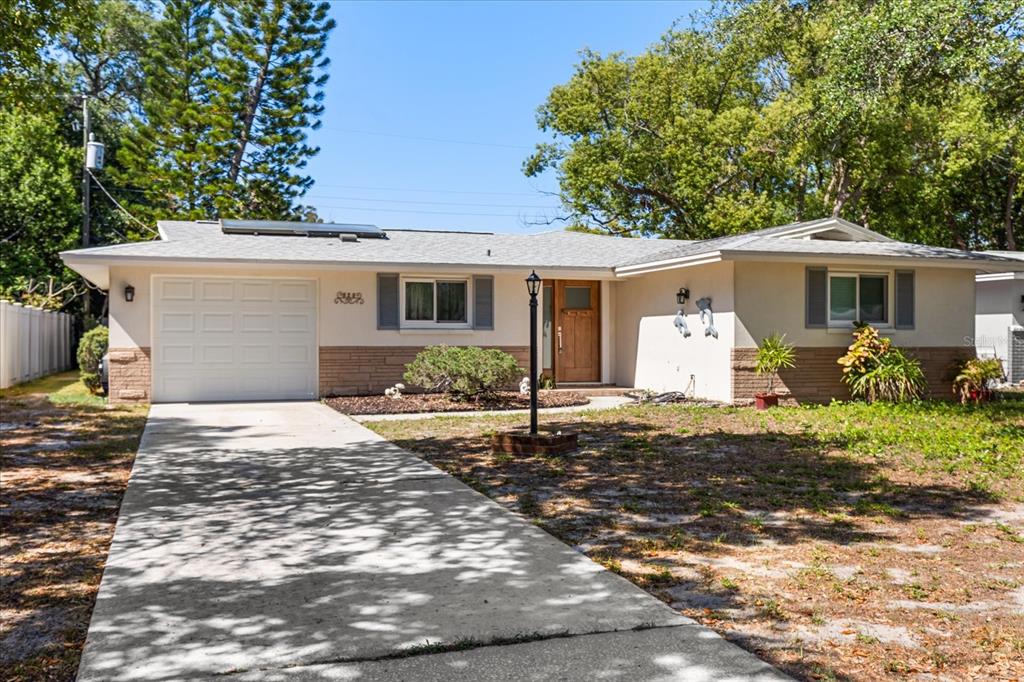 620 Jacaranda Street Dunedin, FL 34698 - Photo 1 of 30 a front view of a house with garden