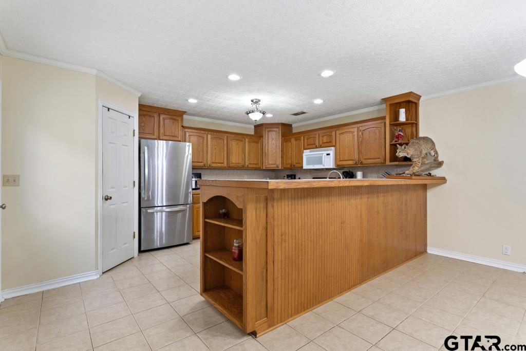 448 North Hill Road Tyler, TX 75706 - Photo 5 of 30 a kitchen with kitchen island a refrigerator sink and stove