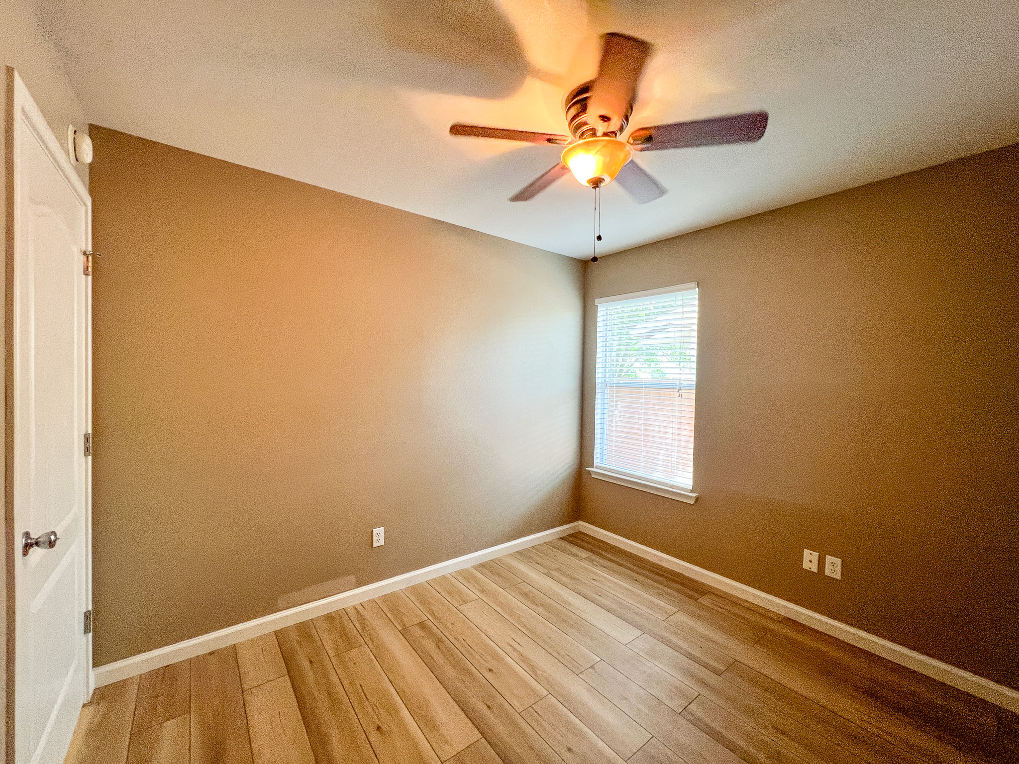 298 Jack Rabbit Lane Buda, TX 78610 - Photo 12 of 24 A quiet bedroom offering durable wood flooring and ample natural illumination.