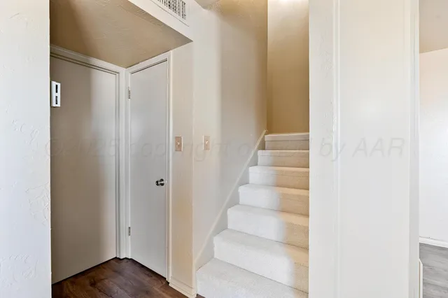 a view of an entryway with wooden floor