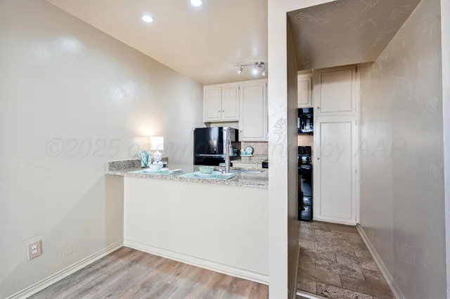 a view of kitchen with refrigerator microwave and stove