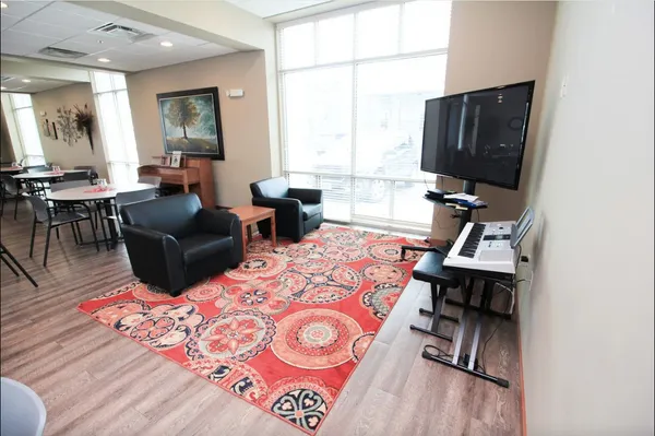a living room with furniture window and a flat screen tv