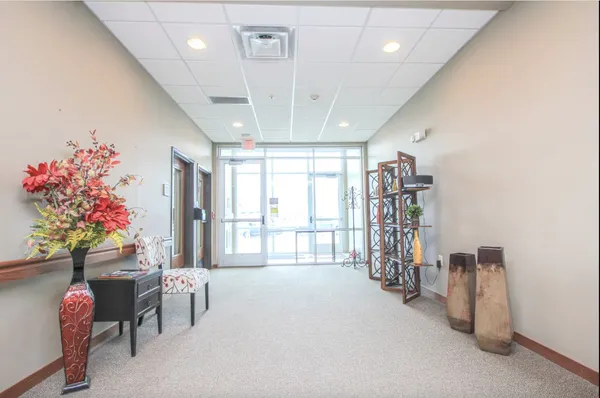 a living room with furniture and flowers