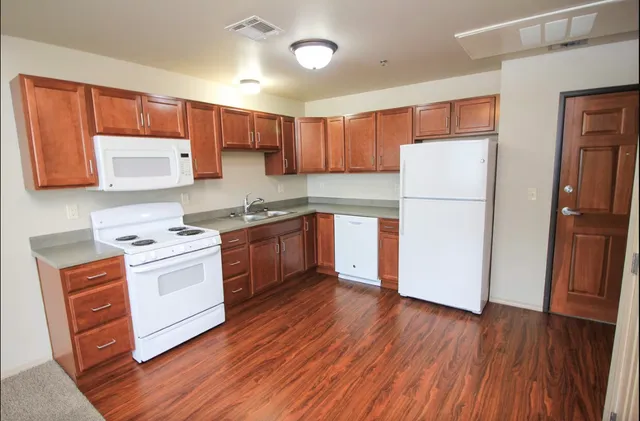 a kitchen with a white stove top oven and refrigerator