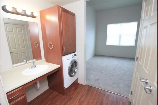 a bathroom with a sink a washer and dryer