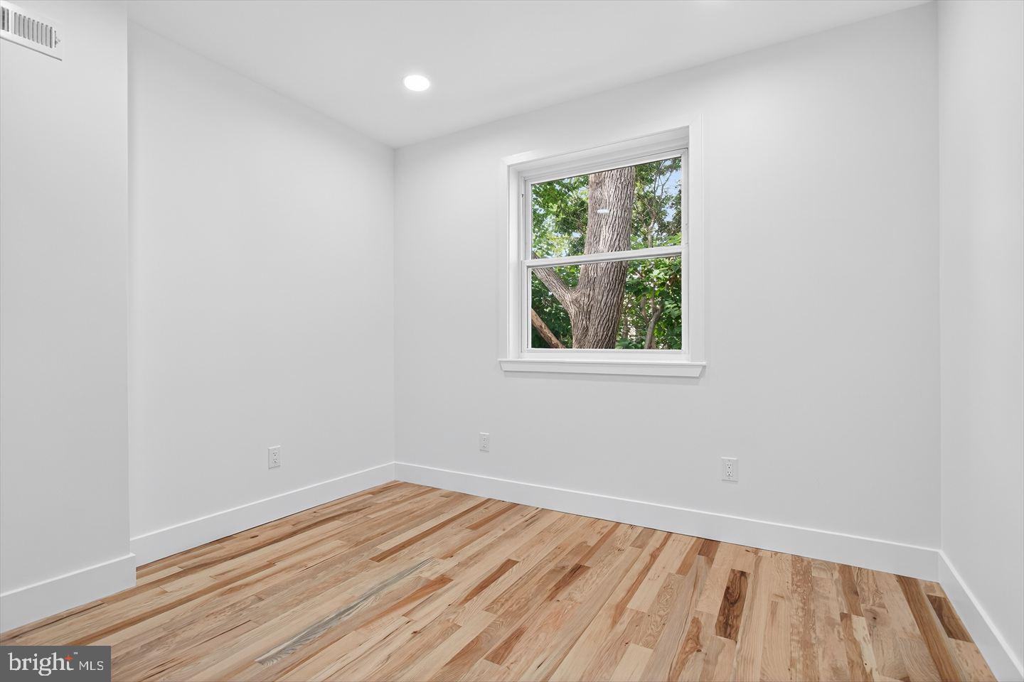 1222 South 26th Street Philadelphia, PA 19146 - Photo 13 of 31 an empty room with wooden floor and windows