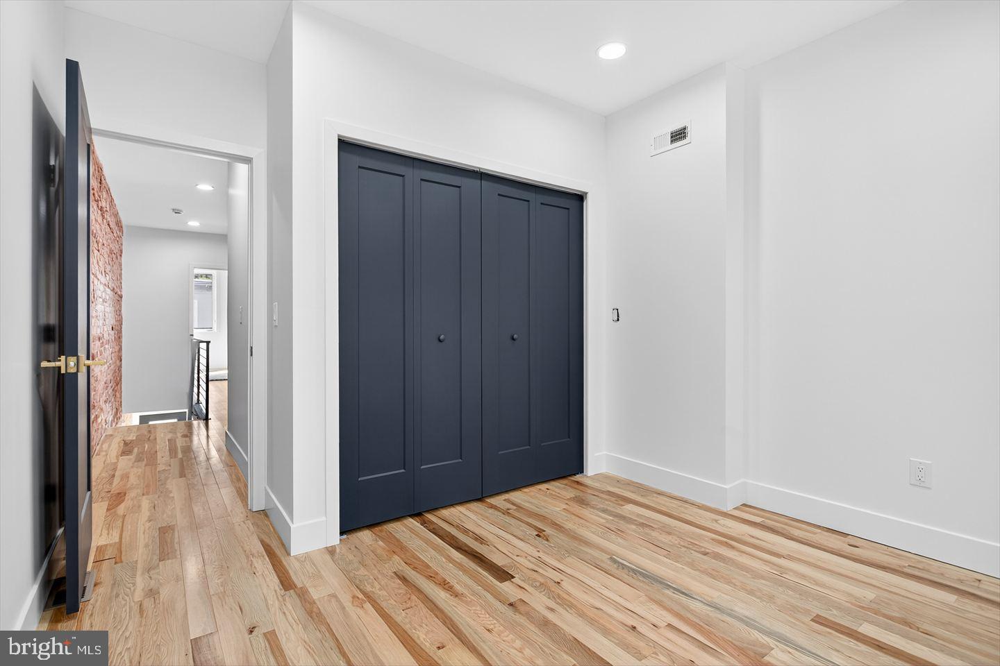 1222 South 26th Street Philadelphia, PA 19146 - Photo 14 of 31 a bedroom with a bed and wooden floor