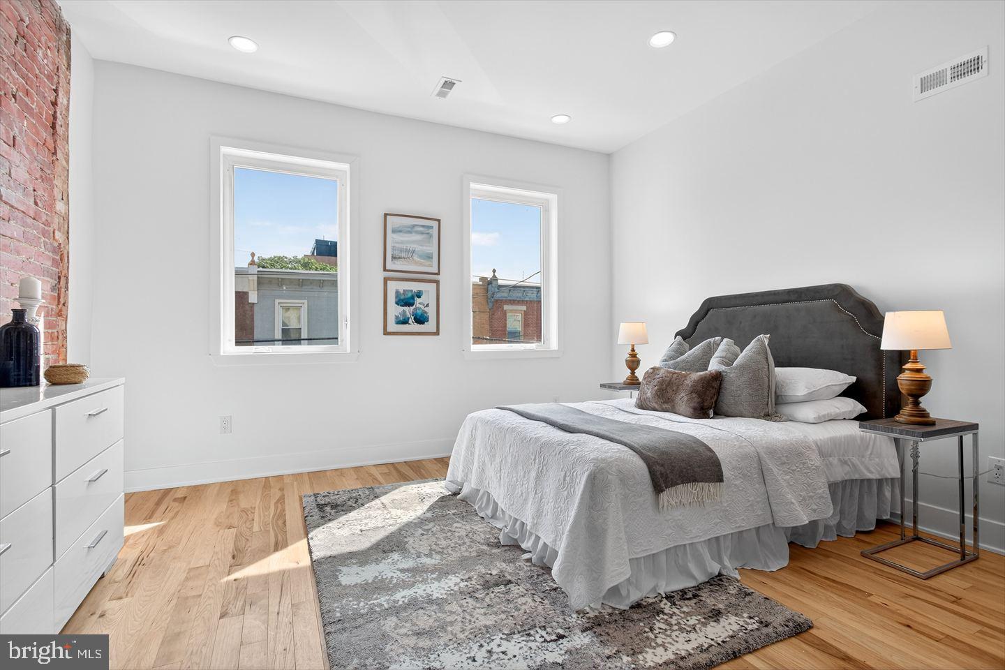 1222 South 26th Street Philadelphia, PA 19146 - Photo 19 of 31 a bedroom with a bed and wooden floor
