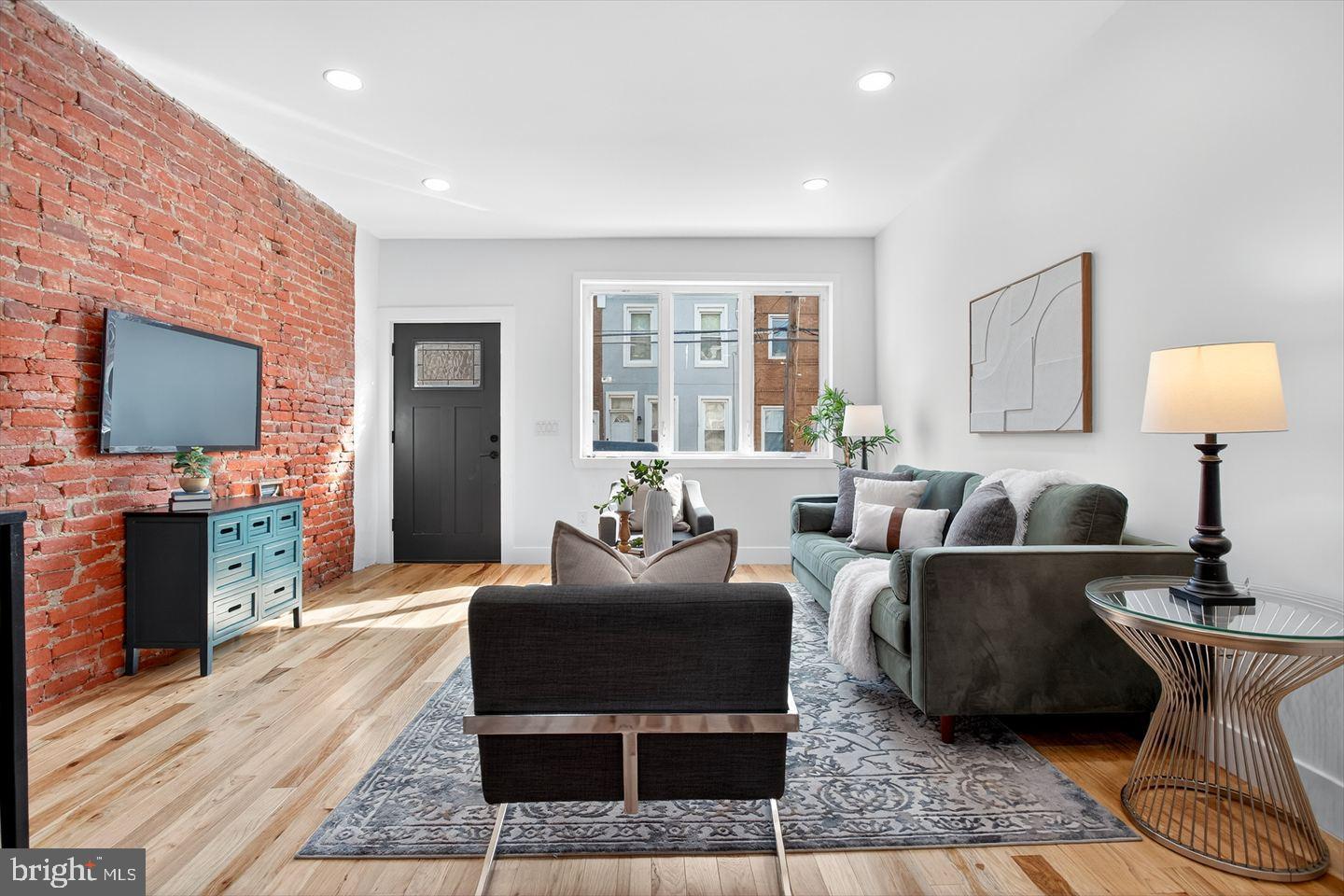 1222 South 26th Street Philadelphia, PA 19146 - Photo 2 of 31 a living room with furniture a flat screen tv and a fireplace