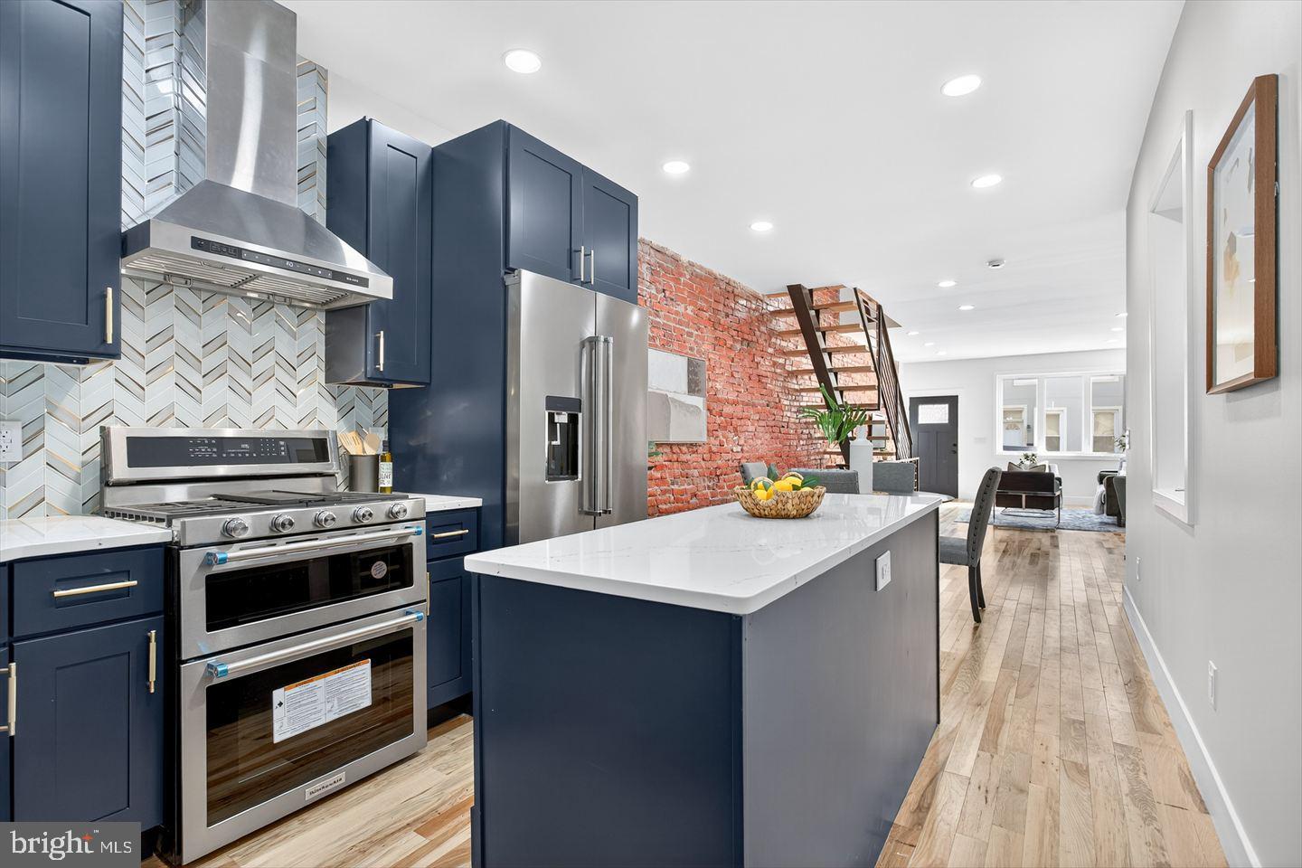 1222 South 26th Street Philadelphia, PA 19146 - Photo 10 of 31 a kitchen with a sink stainless steel appliances and wooden floor