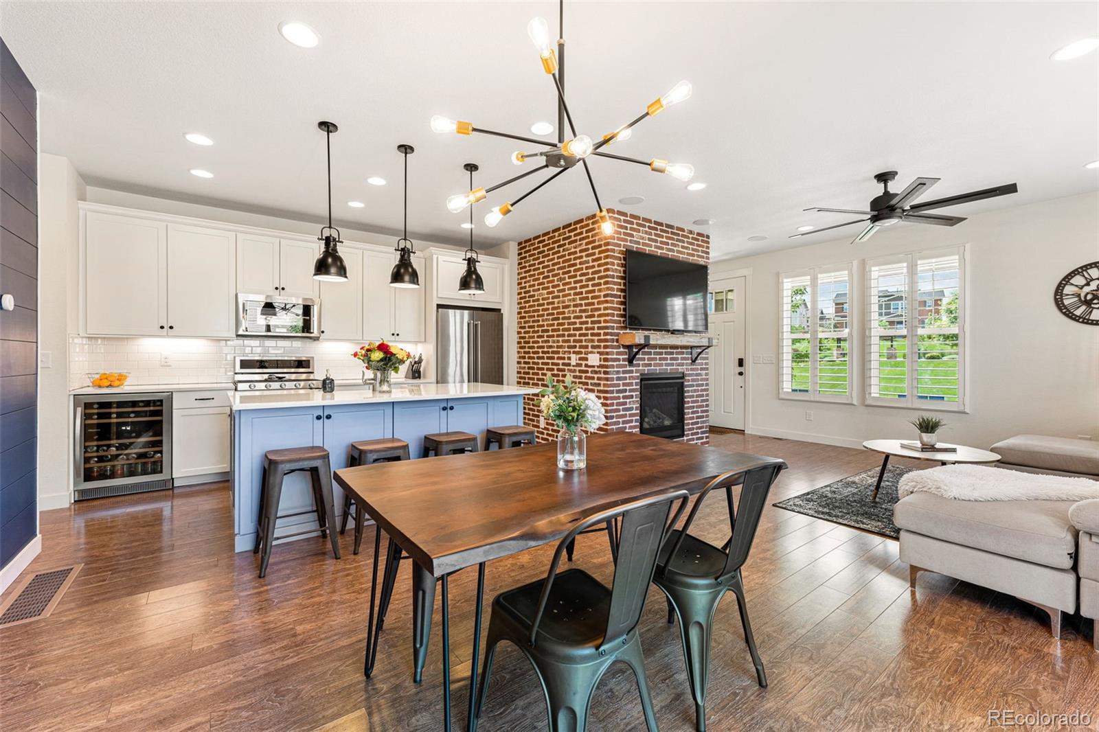 16469 Zuni Place Broomfield, CO 80023 - Photo 1 of 33 a kitchen with granite countertop a table chairs stainless steel appliances and wooden floor