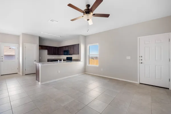 a view of a kitchen with a sink and dishwasher a refrigerator with white cabinets