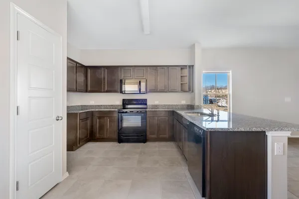 a kitchen with stainless steel appliances granite countertop a refrigerator stove and sink