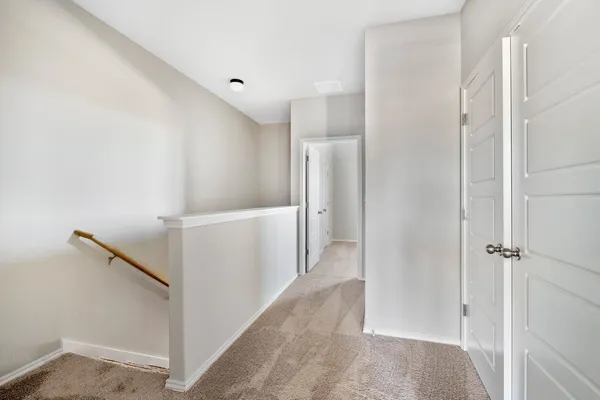 a view of a hallway with closet and door
