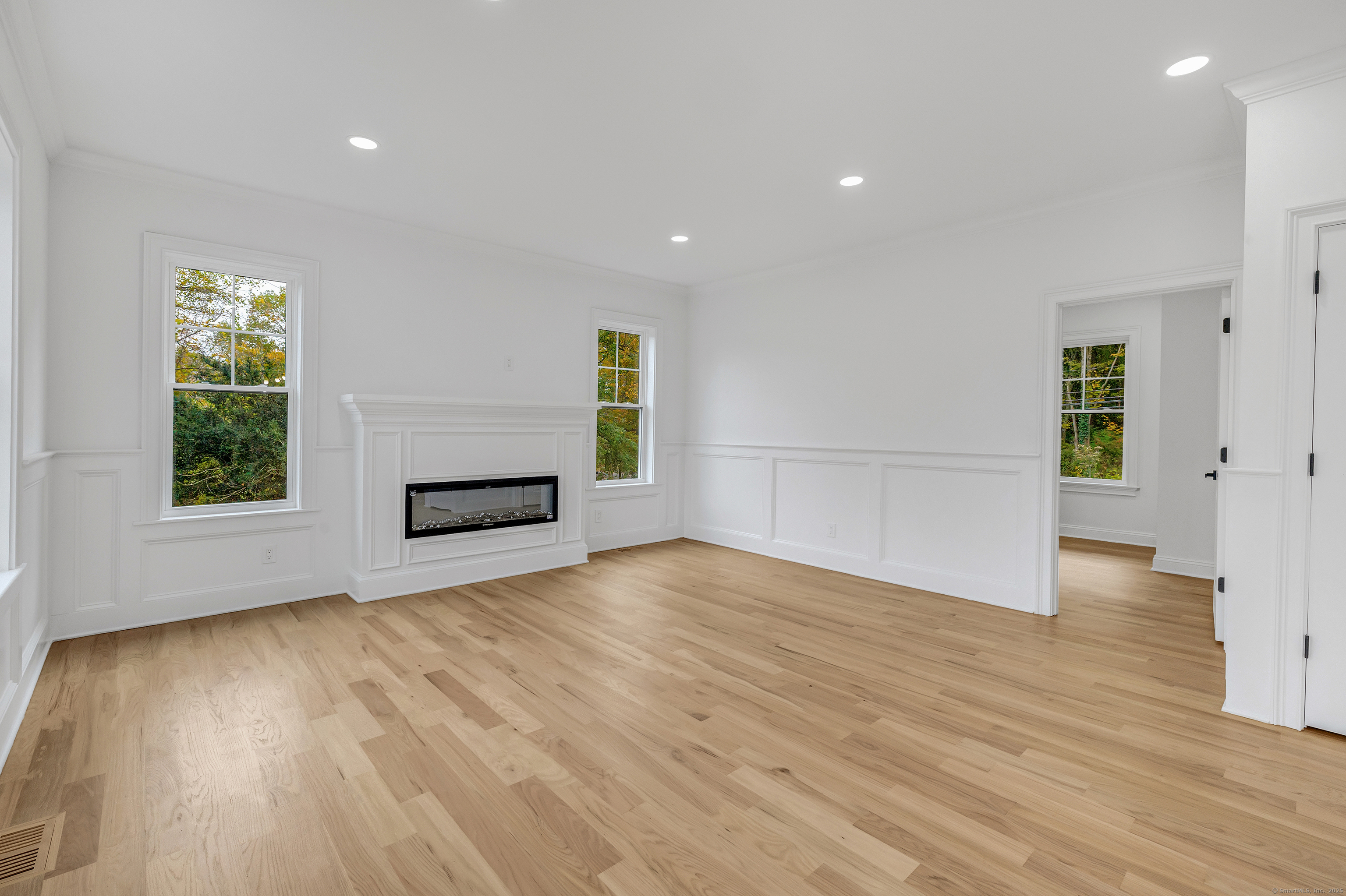 128 Barn Hill Road Monroe, CT 06468 - Photo 11 of 40 a view of empty room with wooden floor and fan