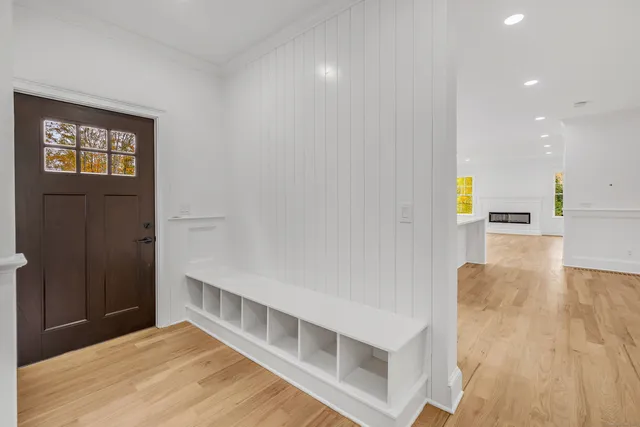 a view of a hallway with wooden floor and staircase