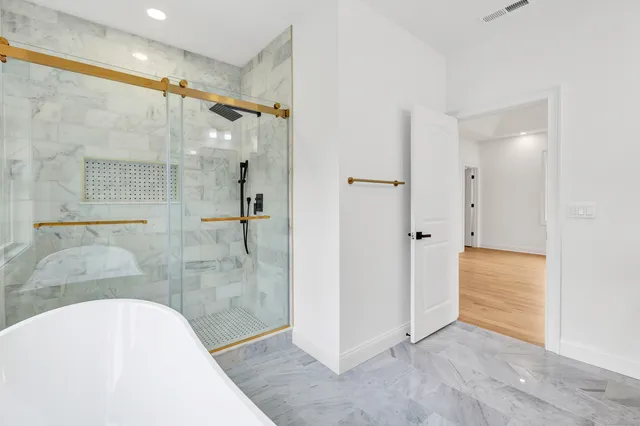 a bathroom with a tub and shower