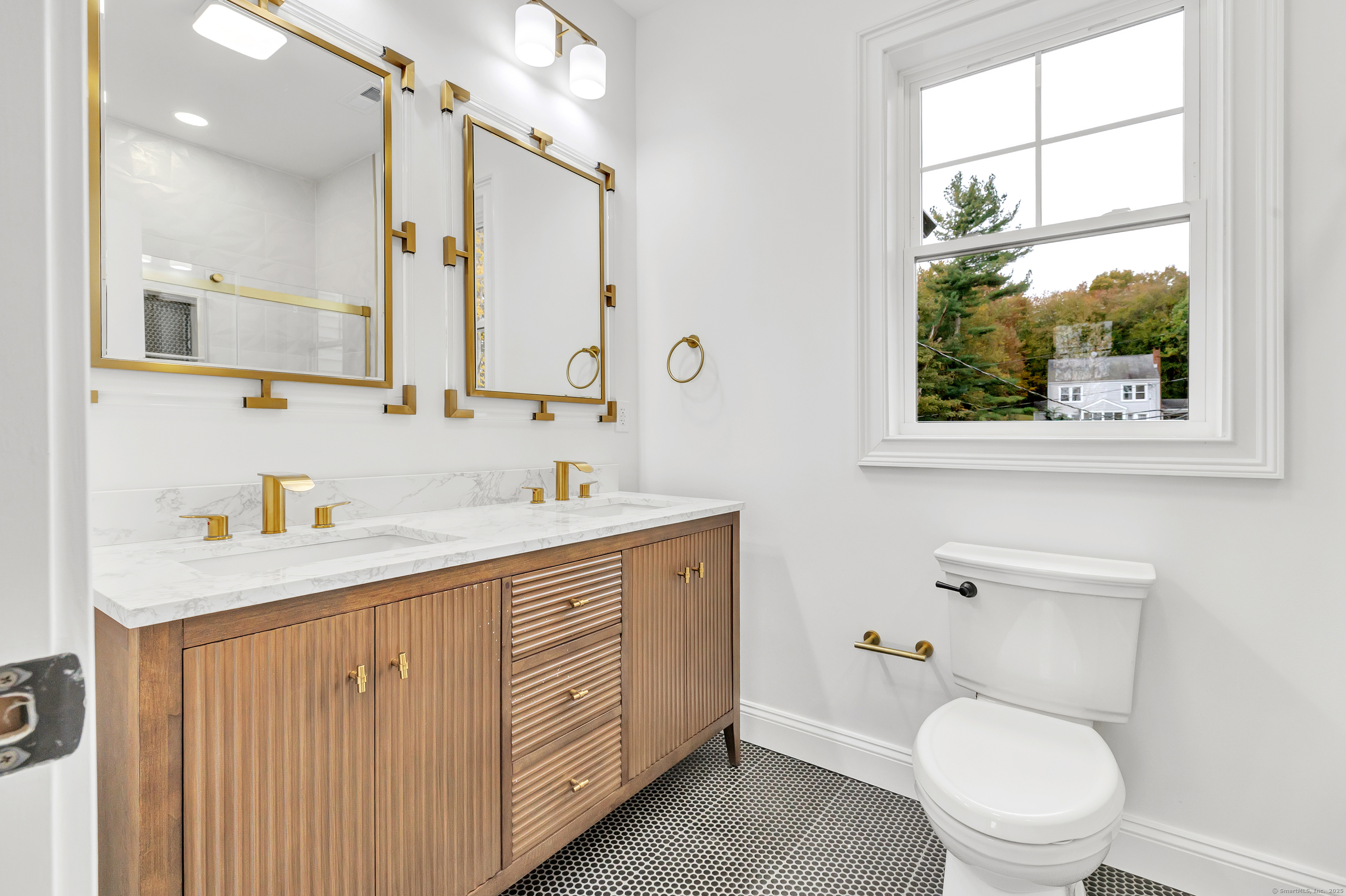 128 Barn Hill Road Monroe, CT 06468 - Photo 29 of 40 a spacious bathroom with a toilet a sink a mirror a window and vanity