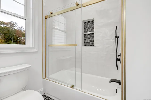 a bathroom with a shower and a toilet