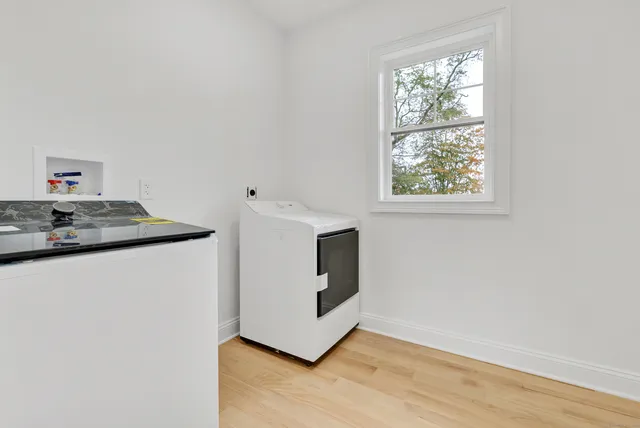 a view of kitchen cabinets and wooden floor