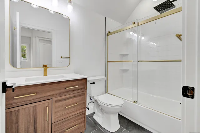 a bathroom with a sink a mirror and a toilet