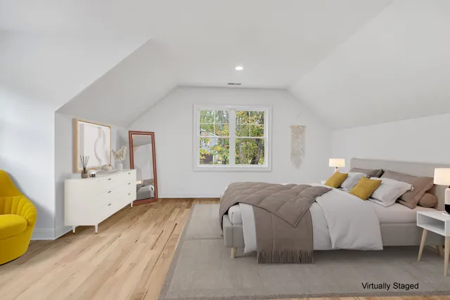 a spacious bedroom with a bed and a couch