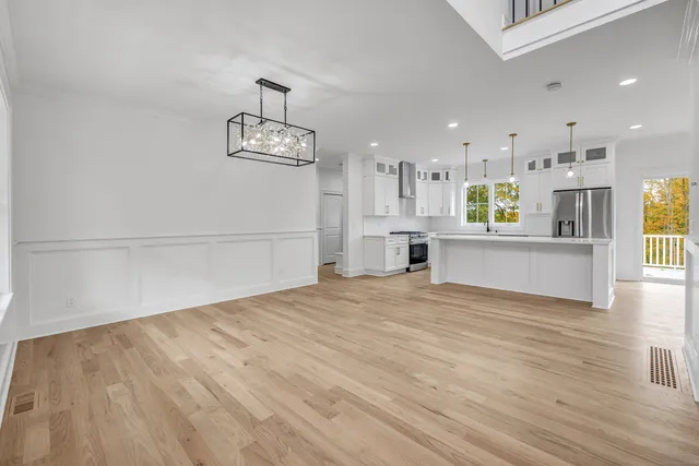a view of a kitchen with wooden floor and a sink