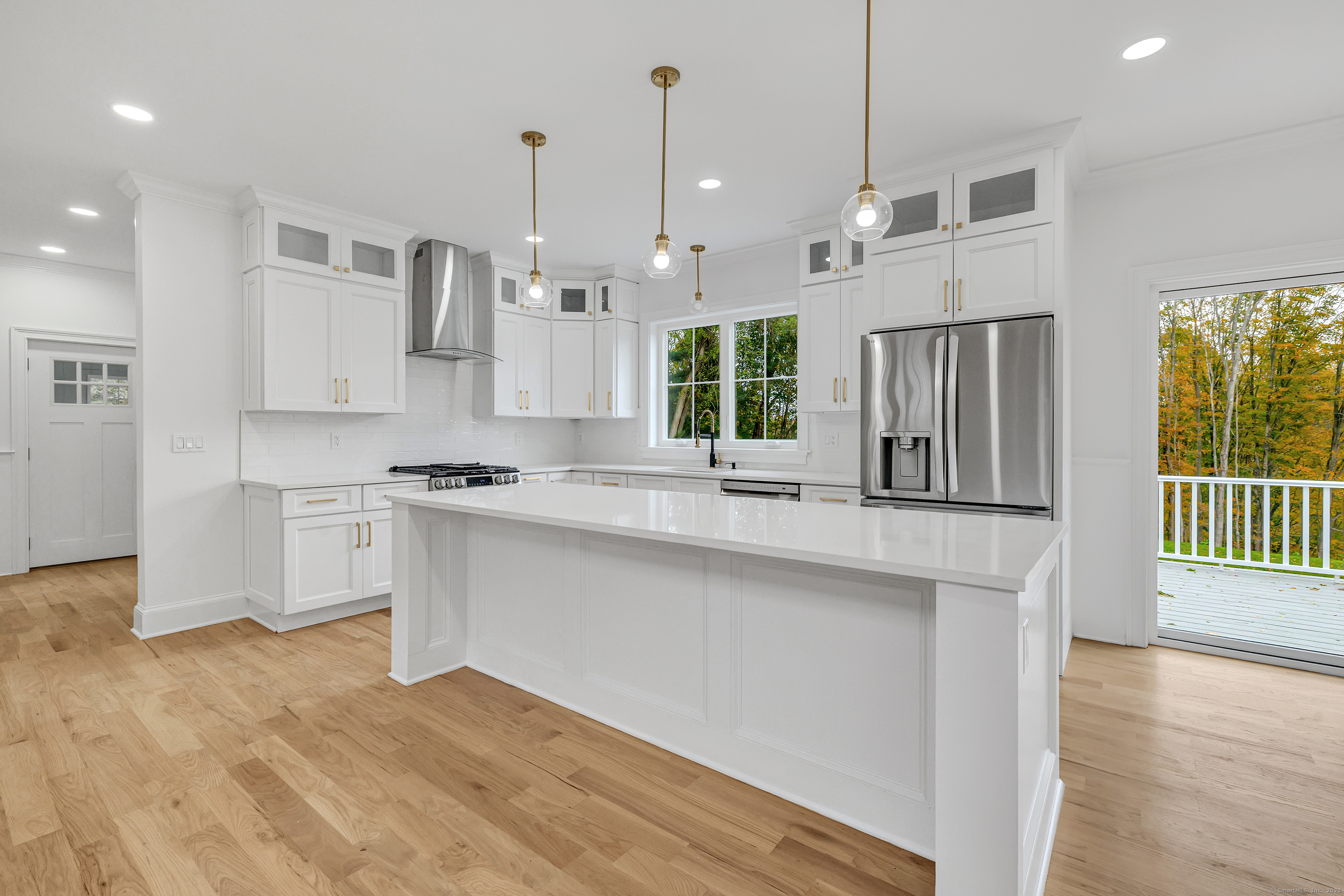 128 Barn Hill Road Monroe, CT 06468 - Photo 8 of 40 a large kitchen with cabinets and wooden floor