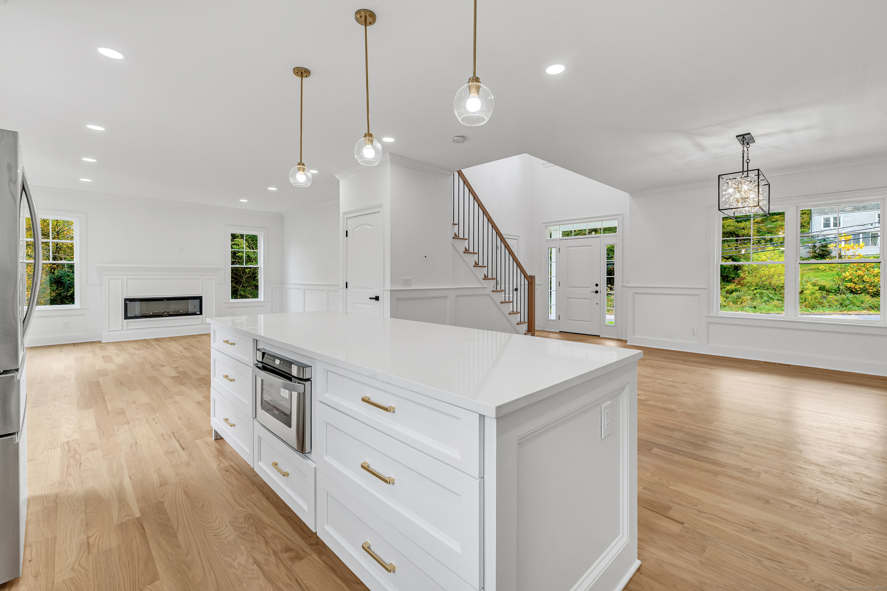 128 Barn Hill Road Monroe, CT 06468 - Photo 10 of 40 a kitchen with a stove a sink a wooden floor and a large window