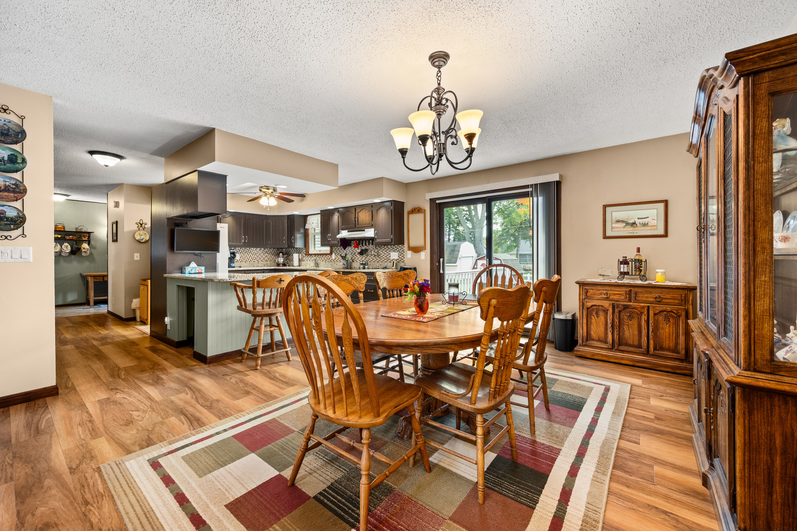 224 Dunkery Drive Sycamore, IL 60178 - Photo 16 of 39 a view of a dining room with furniture a chandelier and wooden floor