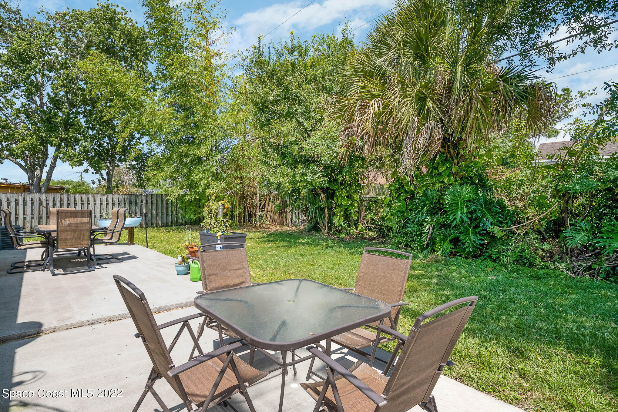1080 Madrid Road Rockledge, FL 32955 - Photo 19 of 21 a view of a chairs and table in the back yard