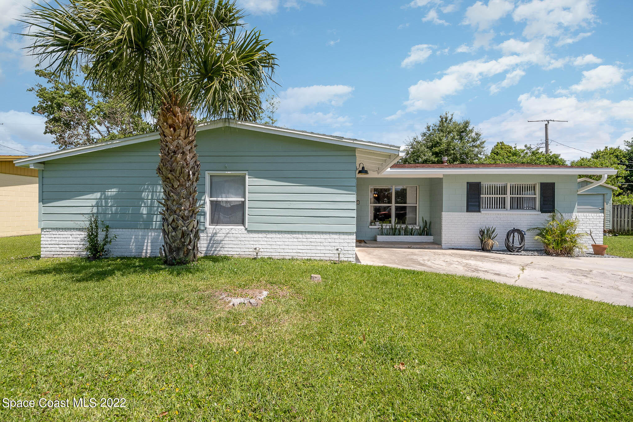 1080 Madrid Road Rockledge, FL 32955 - Photo 2 of 21 a front view of a house with a garden and yard
