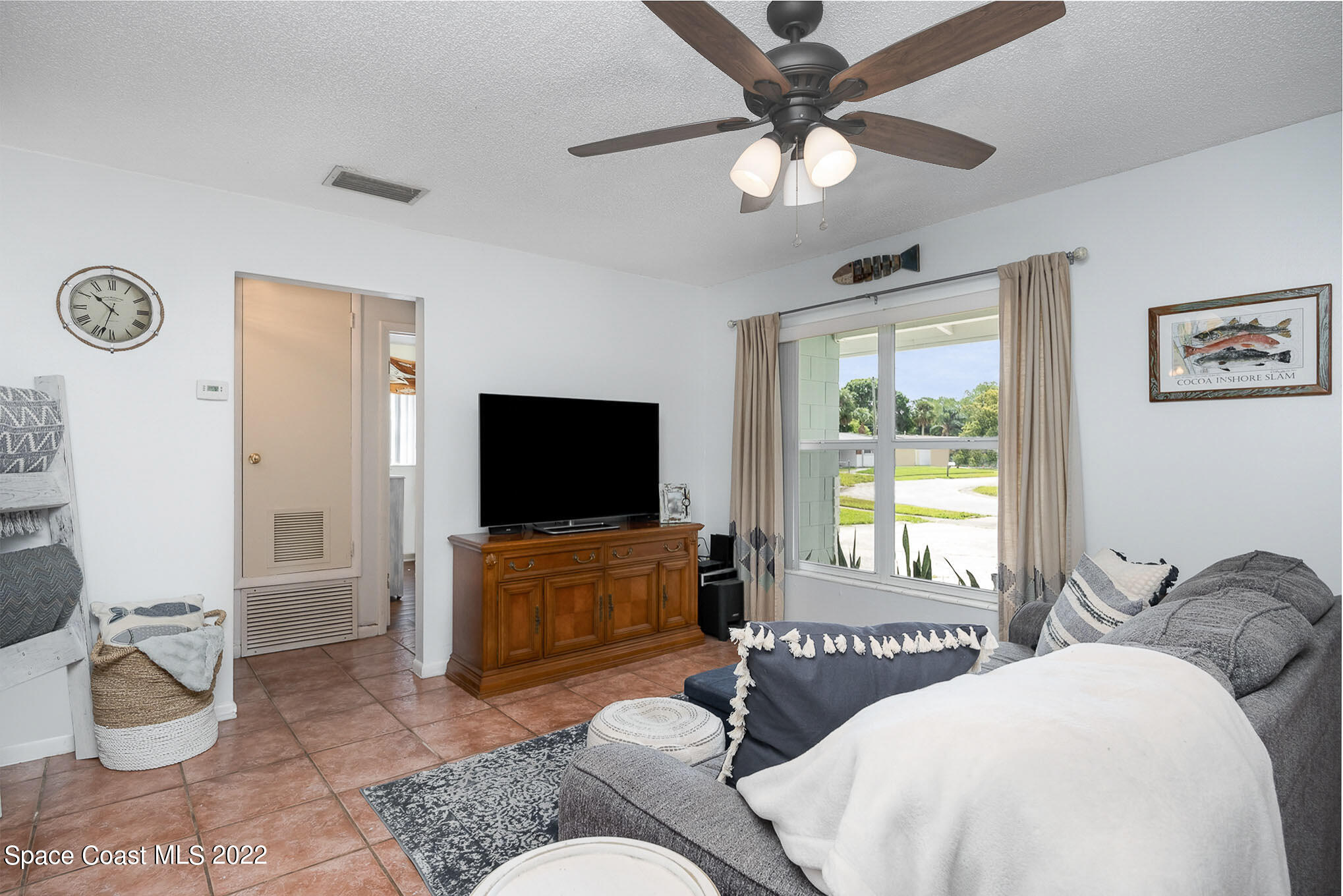 1080 Madrid Road Rockledge, FL 32955 - Photo 3 of 21 a living room with furniture and a flat screen tv