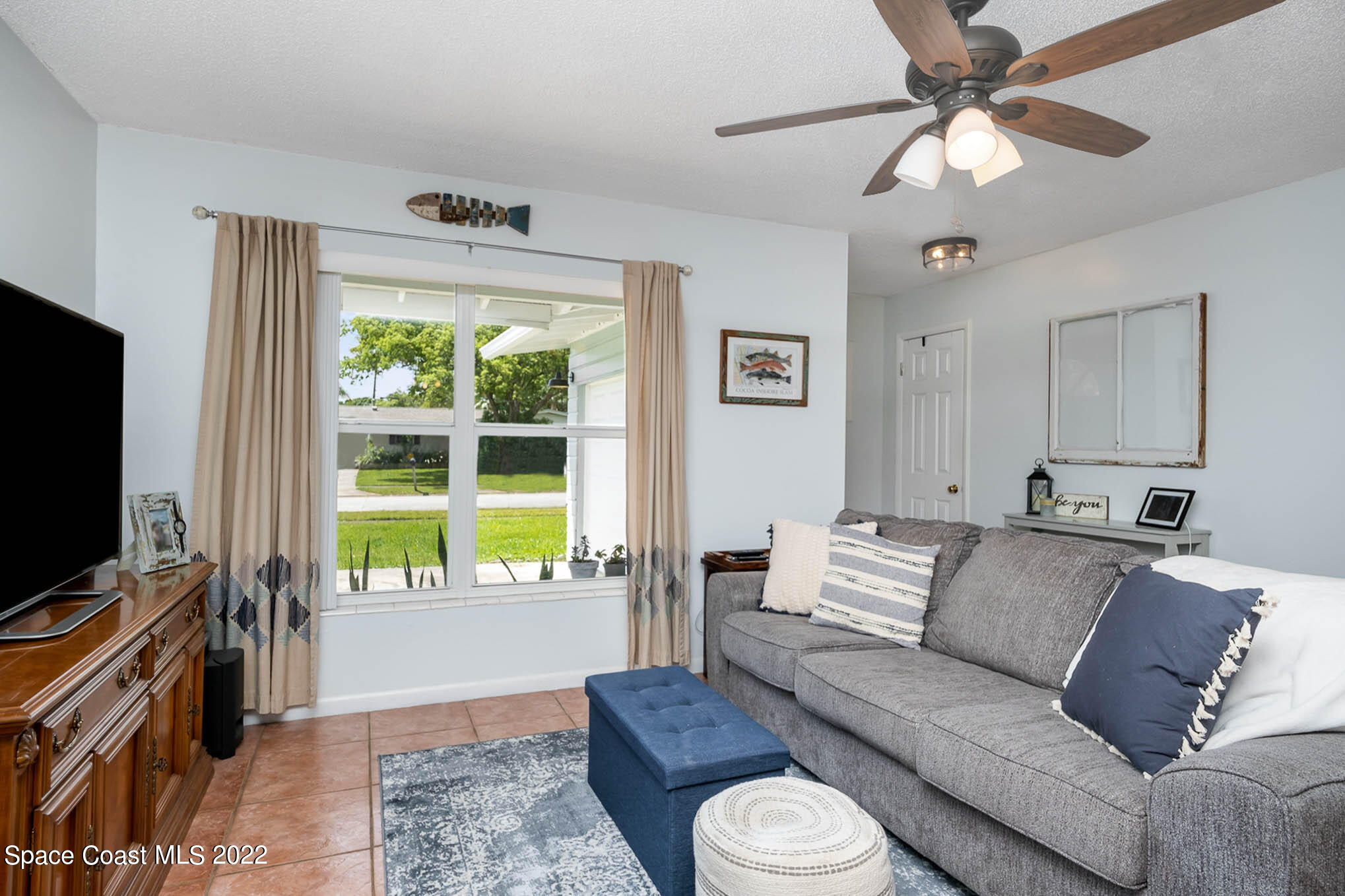 1080 Madrid Road Rockledge, FL 32955 - Photo 4 of 21 a living room with furniture and a flat screen tv