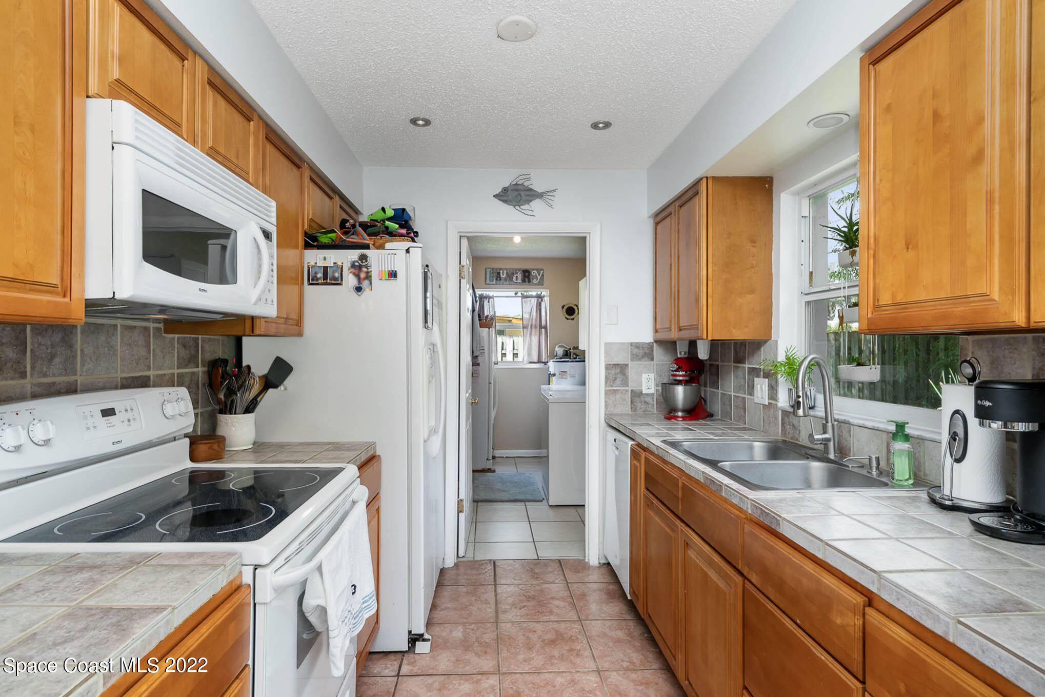 1080 Madrid Road Rockledge, FL 32955 - Photo 7 of 21 a kitchen with a sink stove and refrigerator