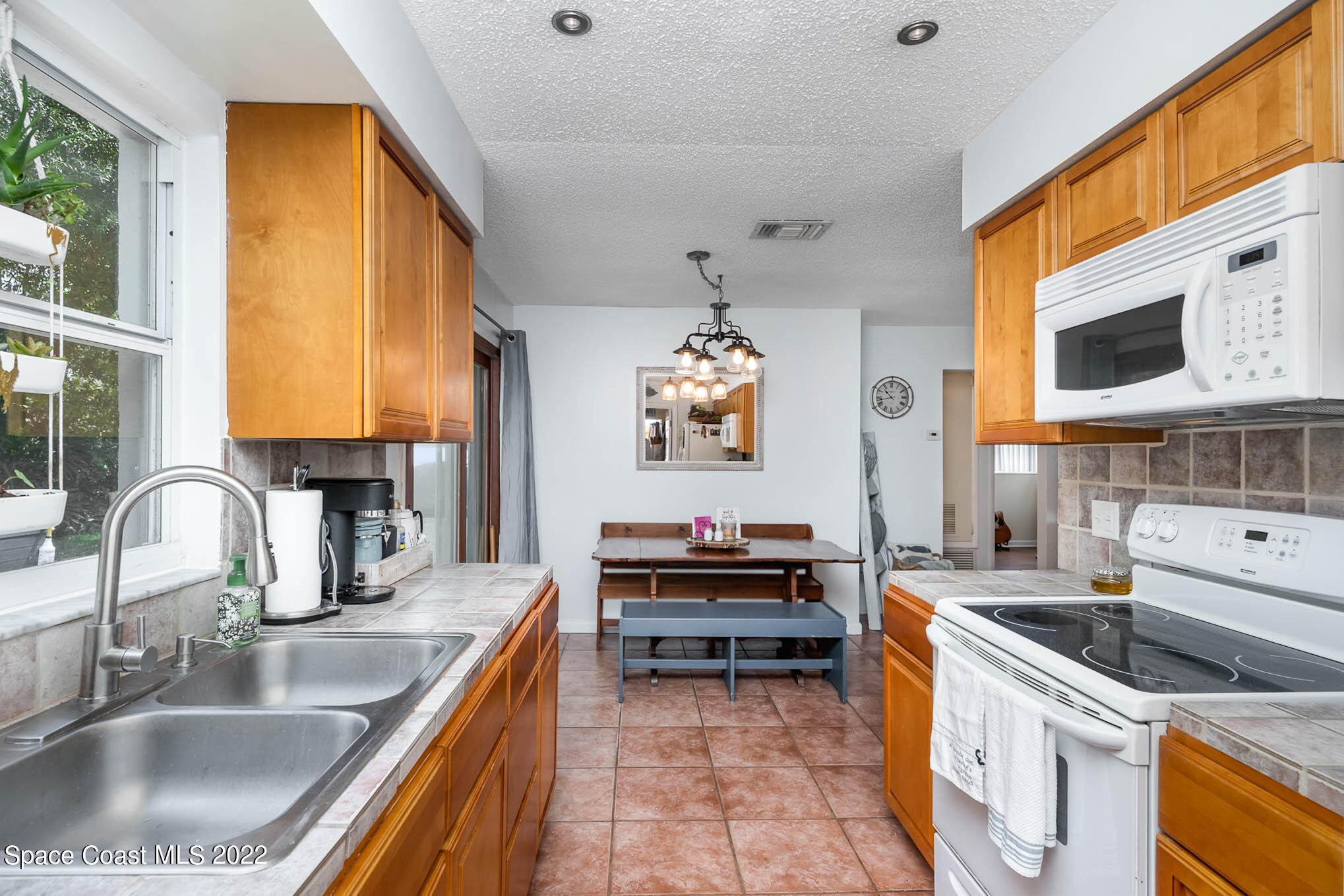 1080 Madrid Road Rockledge, FL 32955 - Photo 8 of 21 a kitchen with kitchen island granite countertop a sink and a counter top space