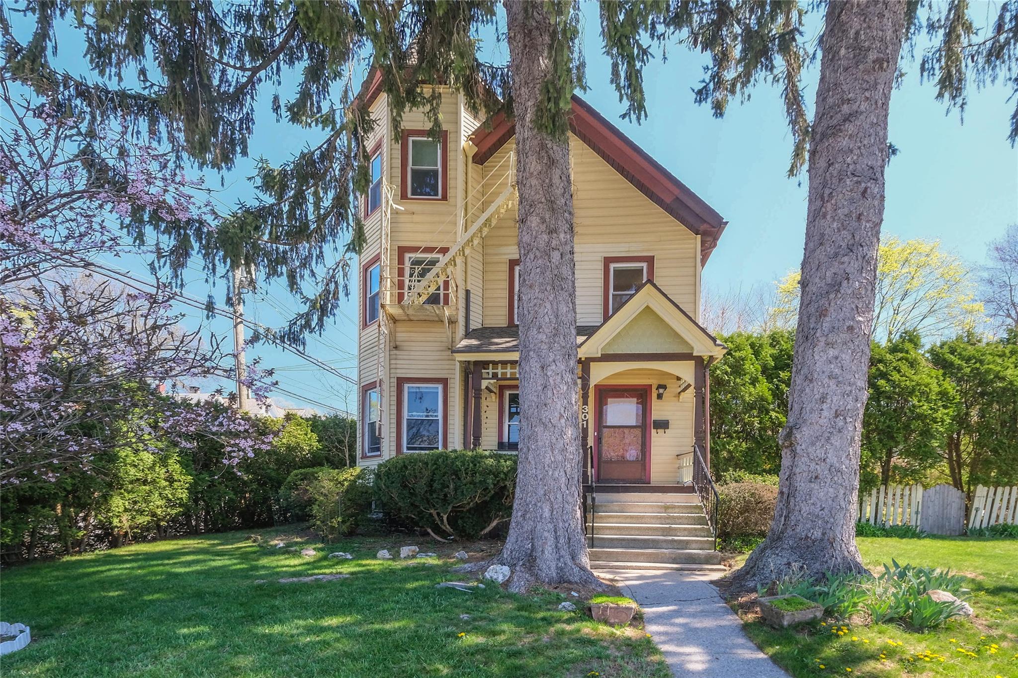 a front view of a house with garden