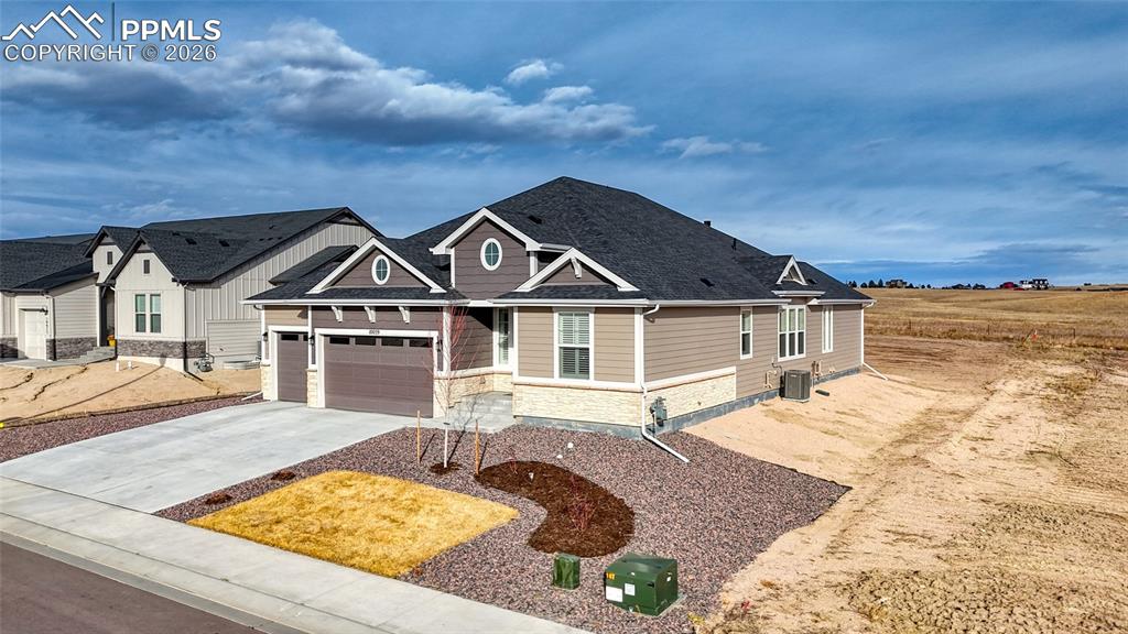 10059 Owl Perch Loop Colorado Springs, CO 80908 - Photo 2 of 50 Craftsman inspired home featuring stone siding, driveway, and an attached garage