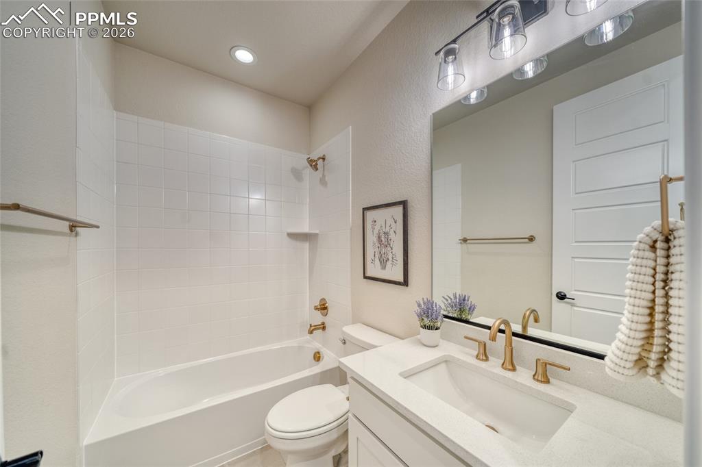 10059 Owl Perch Loop Colorado Springs, CO 80908 - Photo 41 of 50 Bathroom with vanity, shower / washtub combination, a textured wall, and recessed lighting