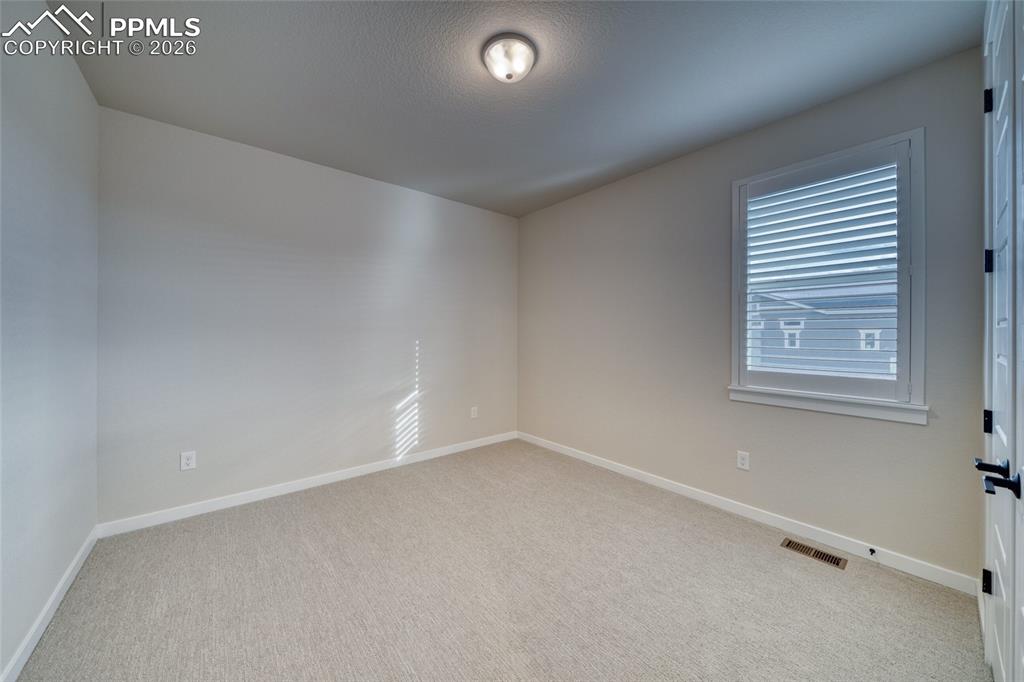 10059 Owl Perch Loop Colorado Springs, CO 80908 - Photo 42 of 50 Unfurnished room with baseboards and light carpet