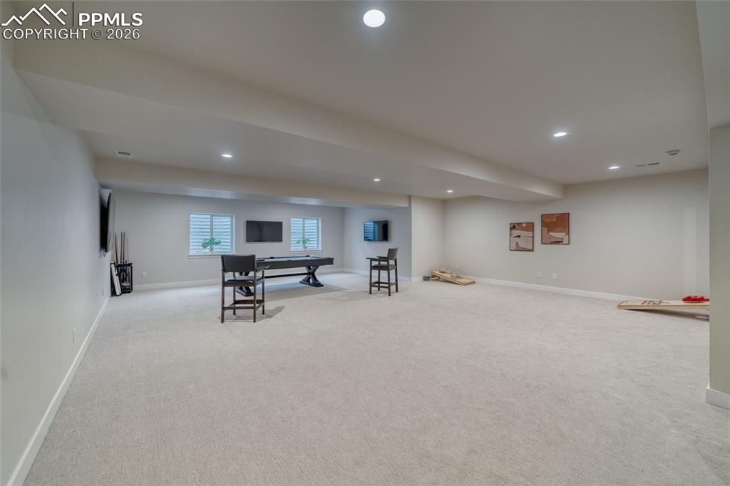 10059 Owl Perch Loop Colorado Springs, CO 80908 - Photo 44 of 50 Rec room with light carpet and recessed lighting