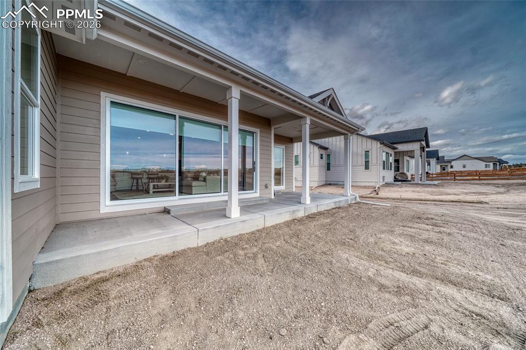 10059 Owl Perch Loop Colorado Springs, CO 80908 - Photo 50 of 50 Back of property with a patio area