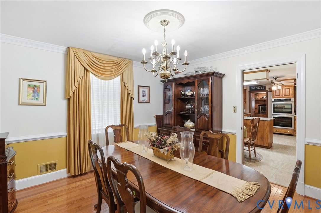 11016 Pridesville Road Amelia Court House, VA 23002 - Photo 21 of 54 a view of a dining room with furniture and wooden floor