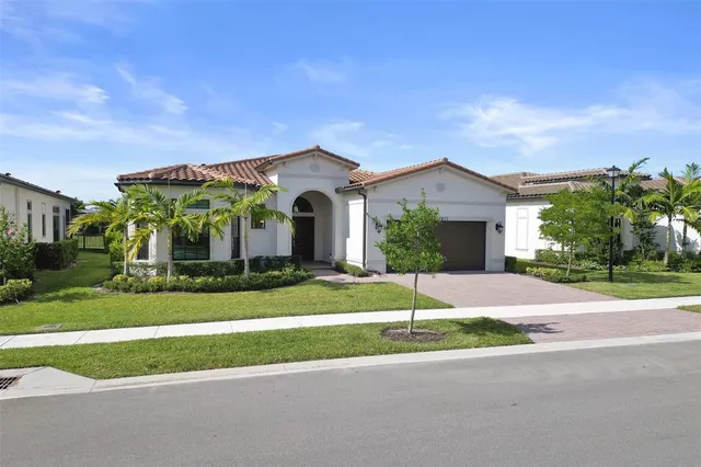 a front view of a house with a yard and garage